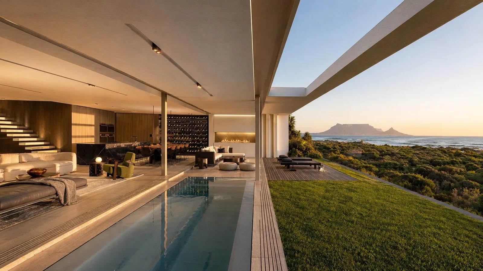 Lap pool and open-plan living pavilion with Table Mountain beyond