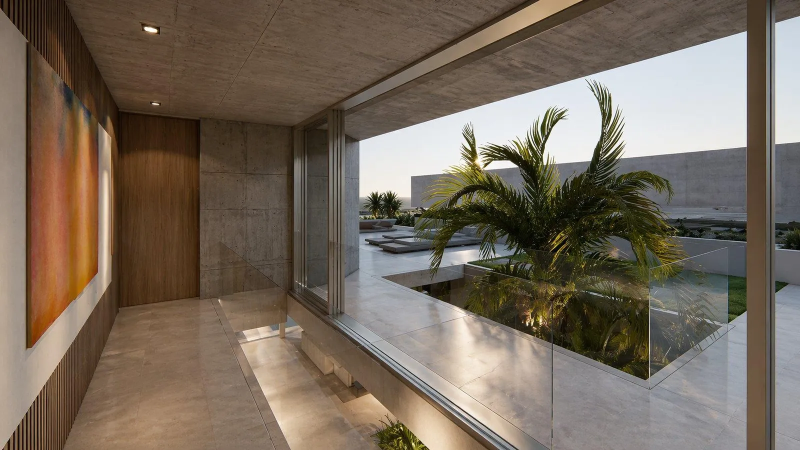 Glazed passage overlooking a planted courtyard
