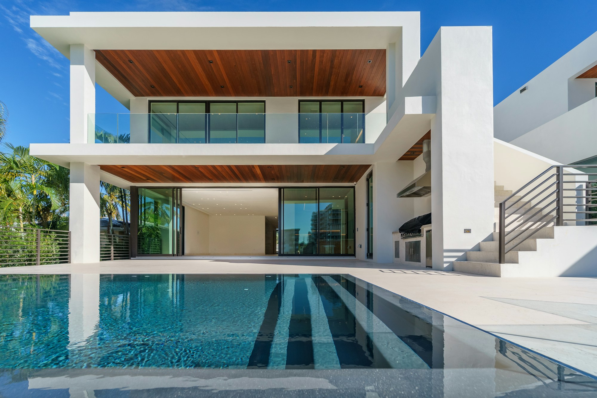 Concept photography of a contemporary home beside a pool; not an available listing